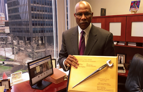 Joseph Haskins Jr. Chairman and CEO of the the Harbor Bank of Maryland, shows an award he received for the bank’s community development work in East Baltimore.